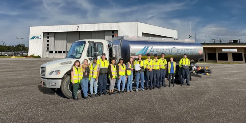 The members of Aero Center TLH in front of a Fuel truck in a group photo